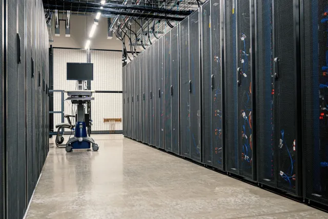 Archive boxes fading on a shelf while a pipe carries data cubes into a warehouse